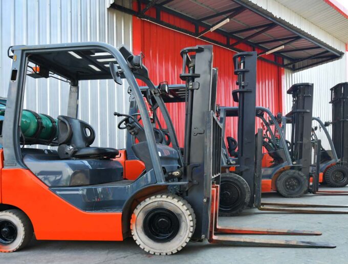 Parked,forklifts,in,warehouse,front
